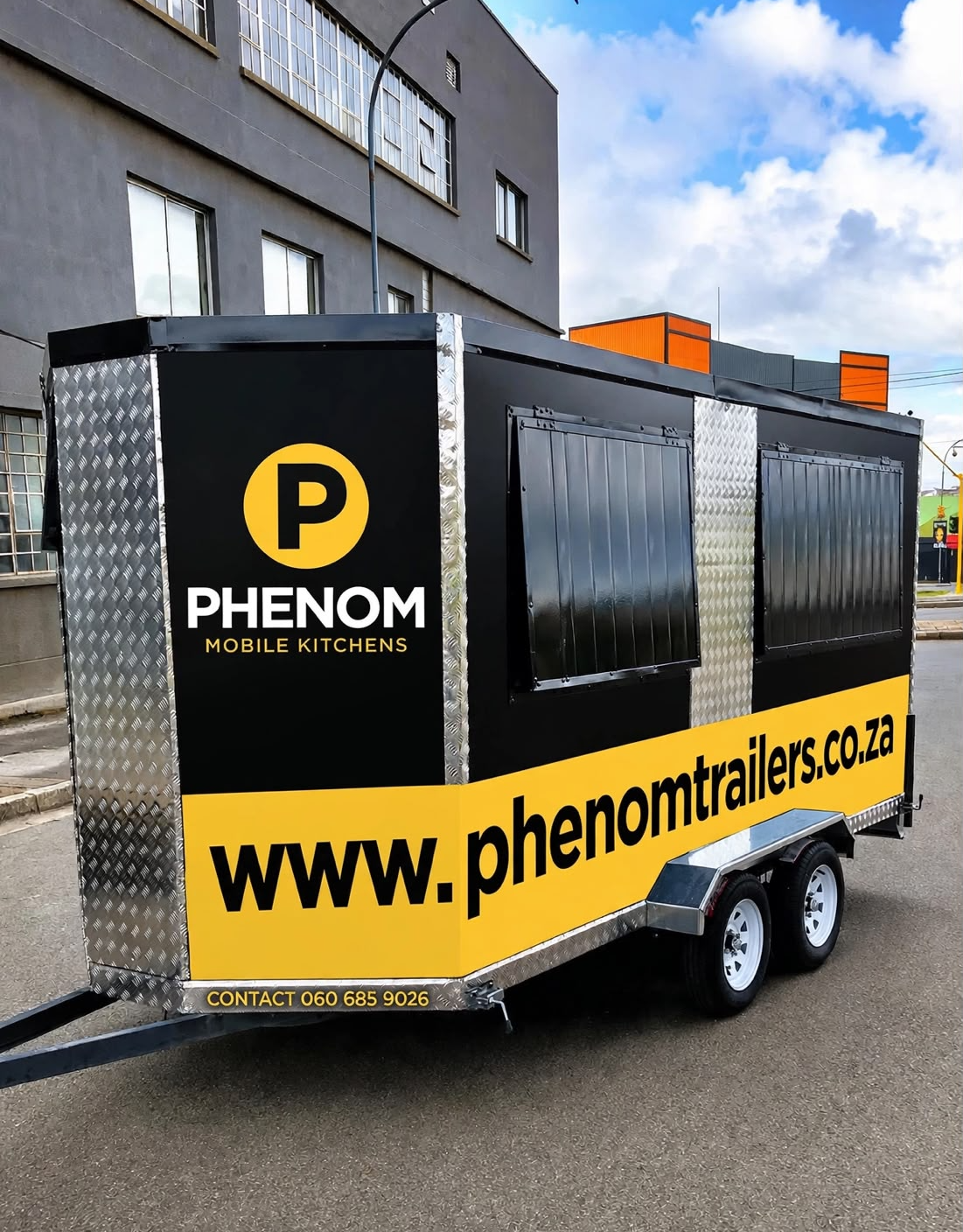 Phenom branded black and gold mobile kitchen trailer