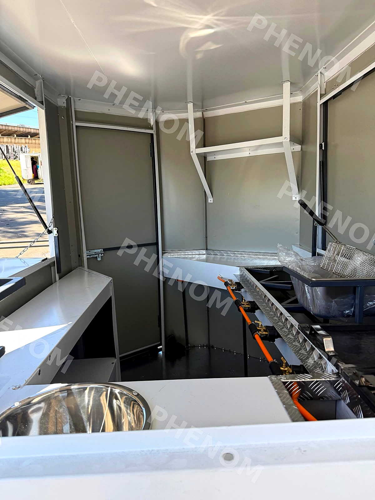 Stainless water basin and prep counter inside a trailer
